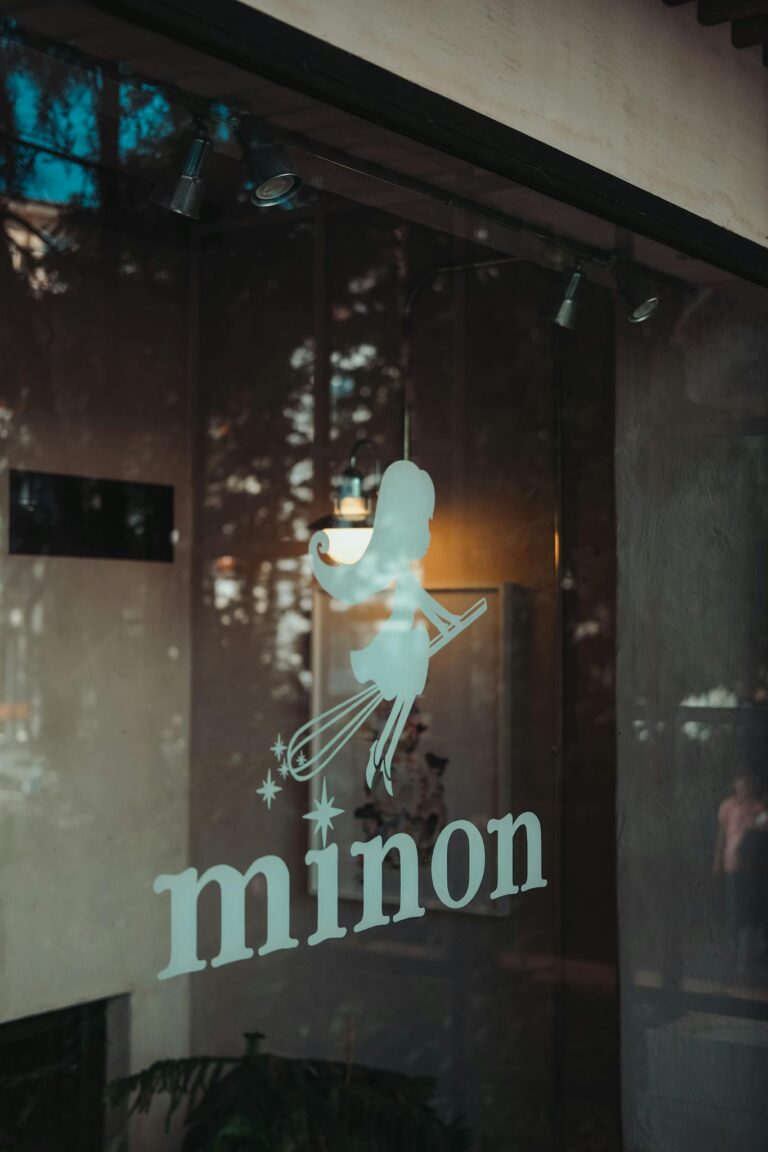 Close-up of a shop window with Minon sign in Ankara, displaying reflections and warm lighting.